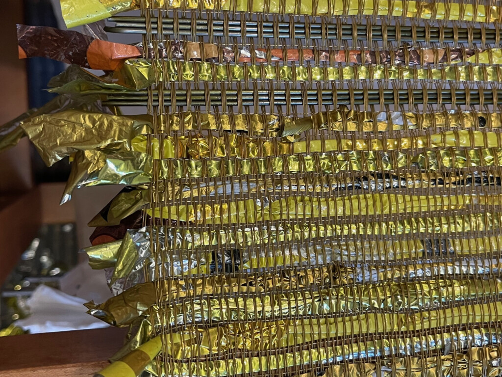 Detail Yellow mylar balloon woven weft dry cleaning hangers New Weave by Suzanne Tick 2025